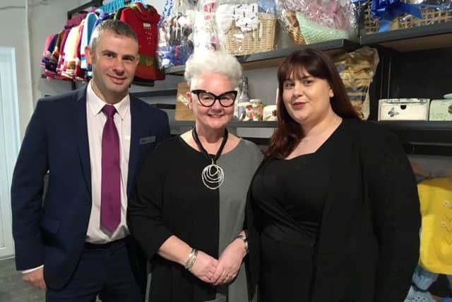 Via Wings founder Gail Redmond (centre) shows Halifax representatives Alan McLachlan and Gillian Boyd around the charity's new social enterprise shop, Wings 'n' Things.