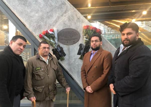 Jonathan Ganesh, Ihsan Bashir, Aazim Ihsan and Hannan Ihsan at the memorial plaque to Inam Bashir and John Jeffries, who were killed in the IRA Docklands bombing on 9 February 1996.