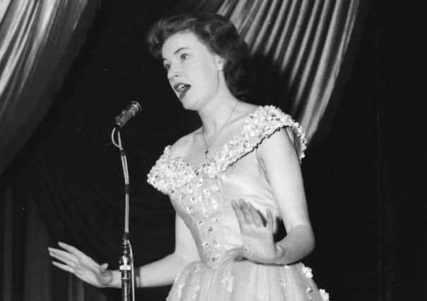 Singer Ruby Murray performing on stage, wearing a flower-detail dress, circa 1955. (Photo by Keystone/Hulton Archive/Getty Images)