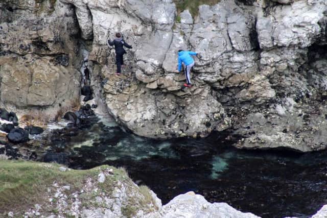 Youths scaling cliffs without any safety equipment at Kenbane near Ballycastle at the weekend. PICTURE KEVIN MCAULEY/MCAULEY MULTIMEDIA