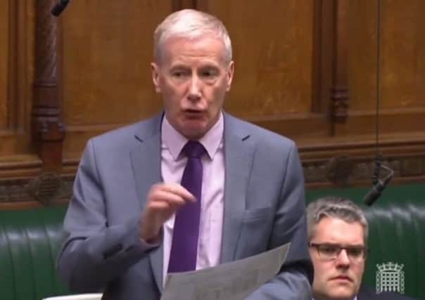 Gregory Campbell, speaking in the House of Commons, holding a print-out of a News Letter story
