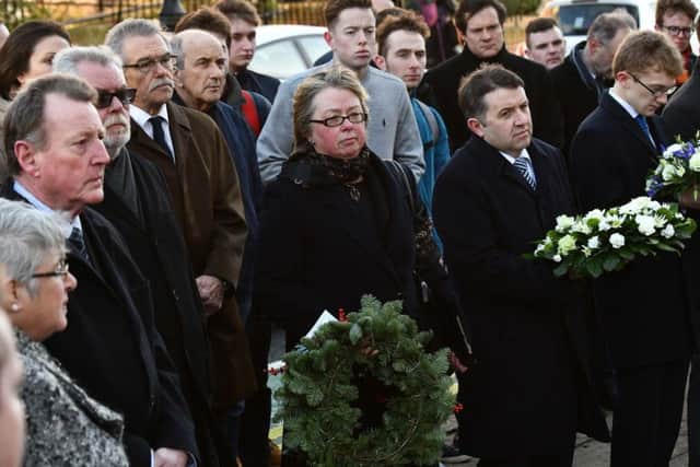 Anne Graham, centre holding wreath, alongside politicians, academics, students and other well wishers, on December 7 2018, marking the 35th anniversary of the murder of her brother Edgar, at the edge of Queen's University. 
Pic Pacemaker