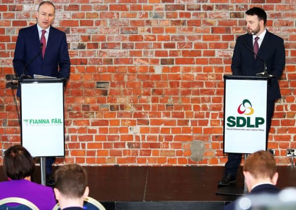 Fianna Fail and SDLP leaders Micheal Martin and Colum Eastwood in Belfast earlier this year. Some SDLP members dislike the new partnership between the parties