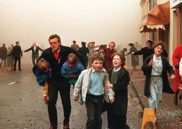 Children and adults, including elderly people, stumble away in horror after the IRA Poppy Day massacre of civilians in Enniskillen in November 1987. Picture Pacemaker