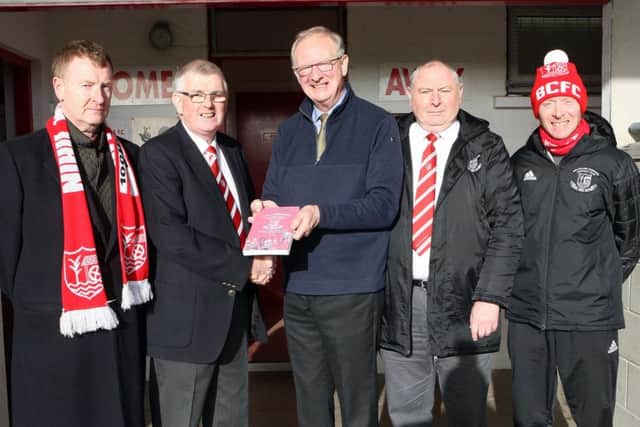 Robson Davison (centre), author of 'The Comrades, presents Trevor McCann, chairman, with the first copy of the special centenary book. Looking on, from left to right, are Seamus Reid, Reid Black Solicitors; Robert Fleck, treasurer and Justyn Wallace, committee member. 
Picture by Freddie Parkinson.