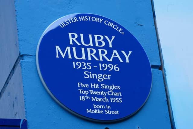The blue plaque on the wall of the Greater Village Regeneration Trust, Donegall Road, Belfast.
 Pic by Arthur Allison.