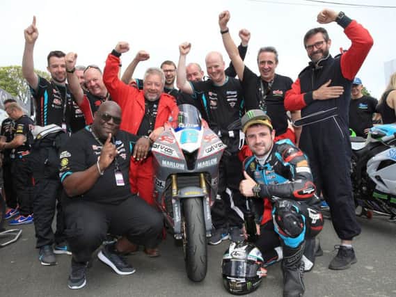 Michael Dunlop celebrates his Supersport TT victory last year with his MD Racing team.