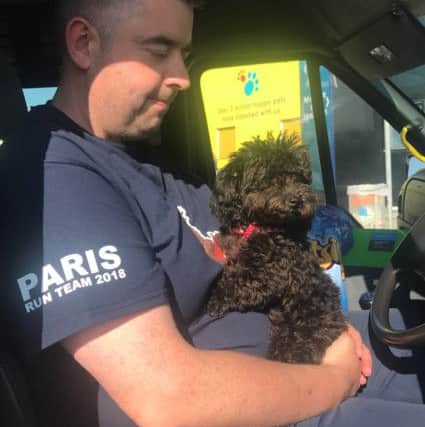 Chris Sheehan holding rescued dog San about to go through Eurotunnel from Paris