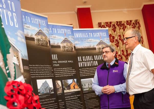 Jonathan Mattison, curator of the Museum of Orange Heritage (left), with Nigel Henderson, History Hub Ulster, viewing the Memorials to Sacrifice exhibition, which will be on display at Sloans House in Loughgall throughout March.
