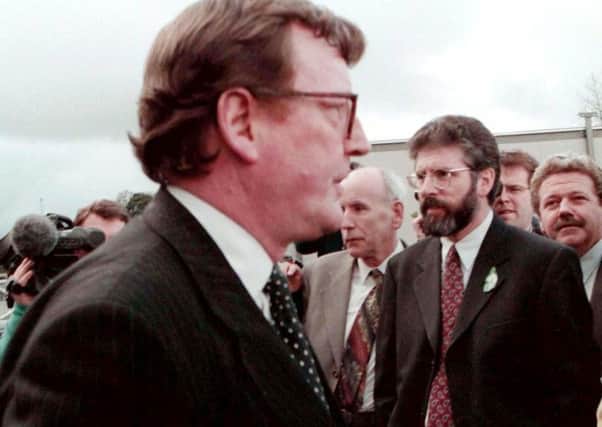 David Trimble and Gerry Adams pass each other during the 1998 Stormont talks. David Barbour says: "I remember David Trimble saying 'Lets go and test them on this' So he jumped, calling on Gerry Adams to follow. It seemed Gerry was behind looking for a parachute"