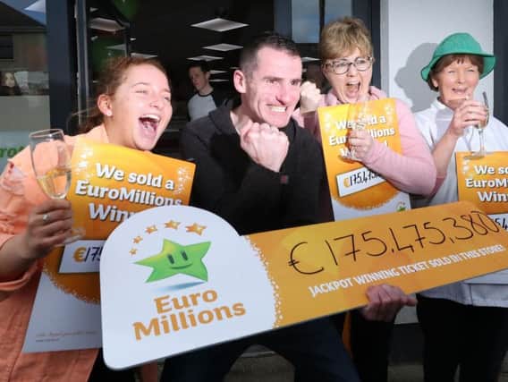 Les Reilly (second left) and the staff of Reilly's Daybreak in Naul, Co Dublin, celebrate selling the EuroMillions 175 million winning lotto ticket