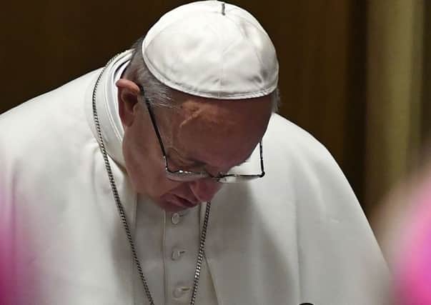 Pope Francis prays at the opening of a sex abuse prevention summit at the Vatican