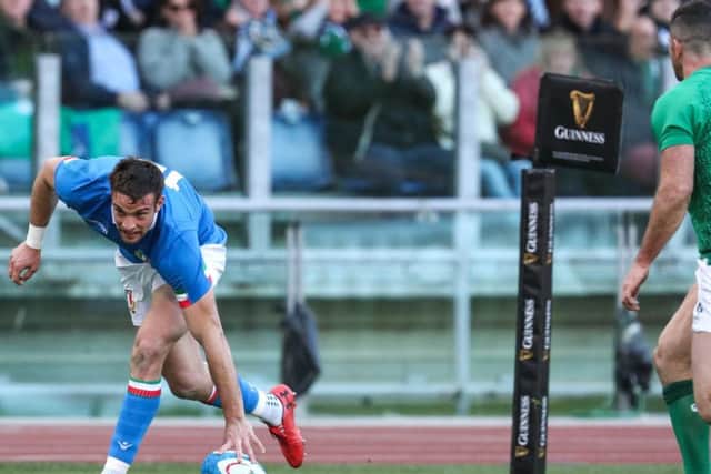 Italy's Edoardo Padovani scores a try