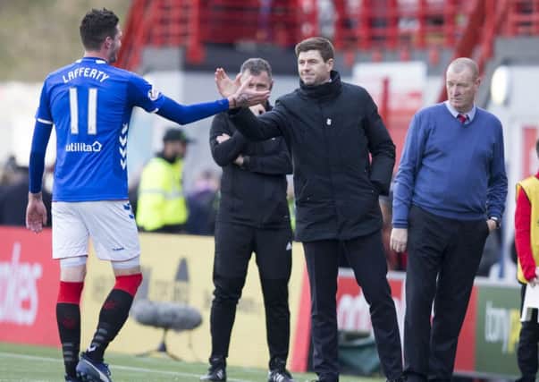 Rangers manager Steven Gerrard shakes hands with Kyle Lafferty at the end of game