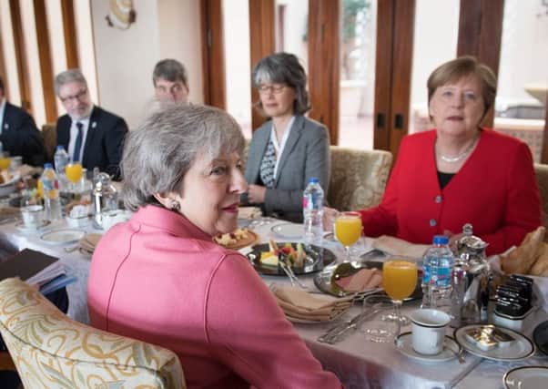 Prime Minister Theresa May (centre) has a breakfast meeting with German Chancellor Angela Merkel (right) at the EU-League of Arab States Summit in  Sharm El-Sheikh, Egypt. Photo credit: Stefan Rousseau/PA Wire
