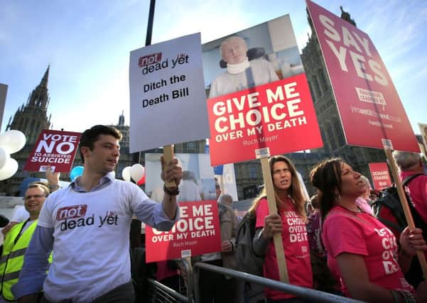 Protesters outside the Houses of Parliament in London as MPs debate and vote on the Assisted Dying Bill on September 11, 2015. The bill was defeated but Lord Carey voiced support for it. Photo: Jonathan Brady/PA Wire