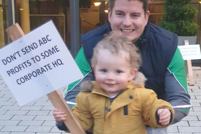 Young Oliver McKenna protesting outside Craigavon Civic Centre with his dad Paul