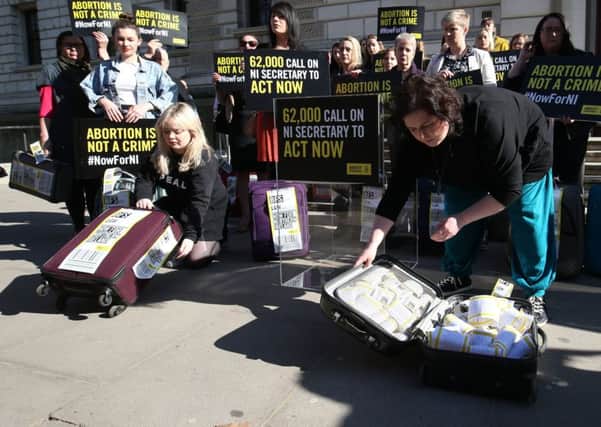 Derry Girls cast members Siobhan McSweeney (right) and Nicola Coughlan open suitcases outside the Treasury in Westminster to reveal the signatures on the petition demanding legislative change on Northern Ireland's strict abortion laws. Photo: Jonathan Brady /PA Wire