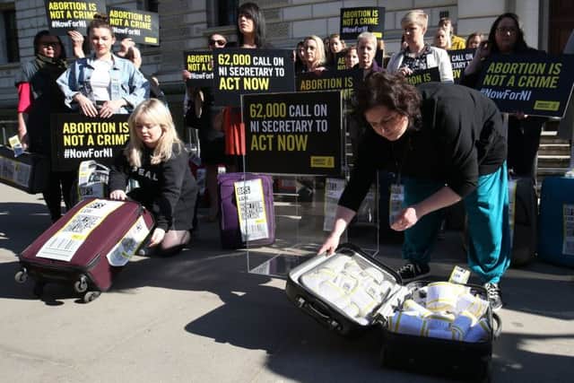Derry Girls cast members Siobhan McSweeney (right) and Nicola Coughlan open suitcases outside the Treasury in Westminster to reveal the signatures on the petition demanding legislative change on Northern Ireland's abortion laws.