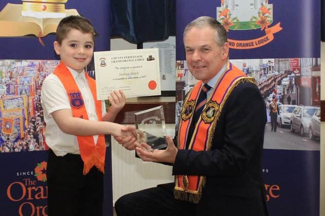 Joshua Black, winner of the youngest junior Orangeman on parade, receiving his award from Stuart Brooker