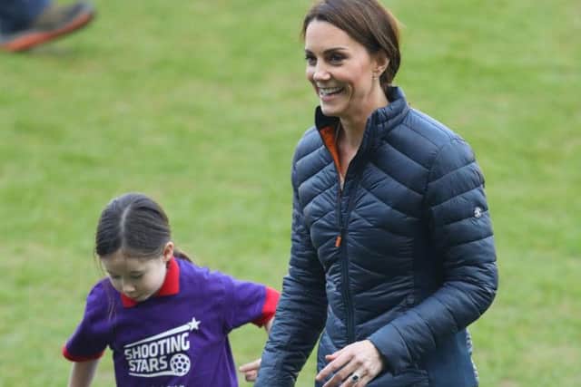 The Duchess of Cambridge tries her hand at football during her visit to Windsor Park, Belfast as part of her and the Duke of Cambridge's two day tour of Northern Ireland.