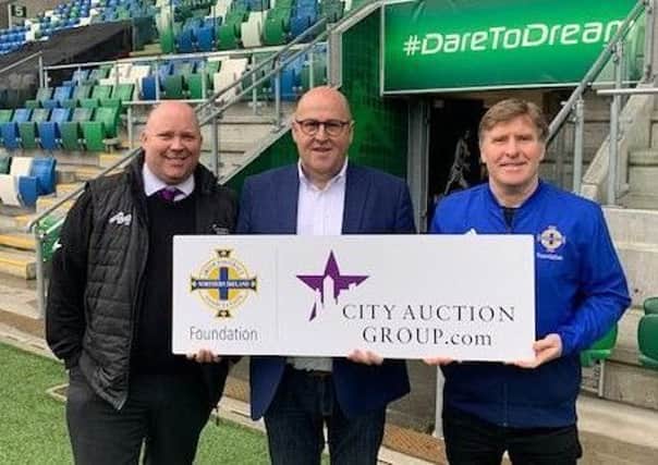 David Scott and Raymond Hill from City Auction Group pictured with Ian Stewart of the Irish FA Foundation to announce the sponsorship deal