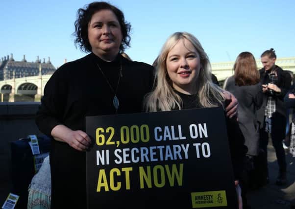 Derry Girls cast members Siobhan McSweeney and Nicola Coughlan (right) join MPs and women impacted by Northern Ireland's strict abortion laws on Westminster Bridge in London. They had a petition of almost 70,000 signatures calling on the Secretary of State to force through reforms.  Photo: Jonathan Brady /PA Wire