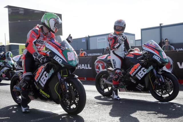 KMR Kawasaki riders Derek McGee (left) and Jeremy McWilliams on the grid at the North West 200 in 2018.