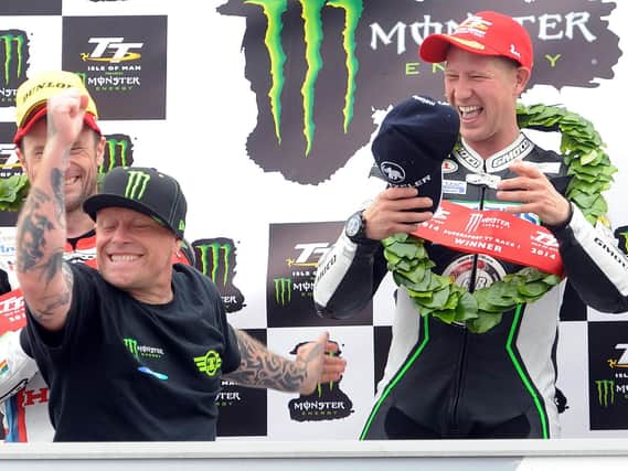 The Prodigy's Keith Flint on the rostrum at the Isle of Man TT with Supersport race winner Gary Johnson in 2014.