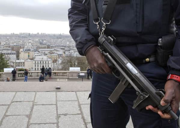 A French police officer patrols the Sacre Coeur basilica, Montmartre, Paris in 2015 after Islamist terrorist attacks led to 10,000 troops being put on to the streets to protect sensitive sites (AP Photo/Jacques Brinon)