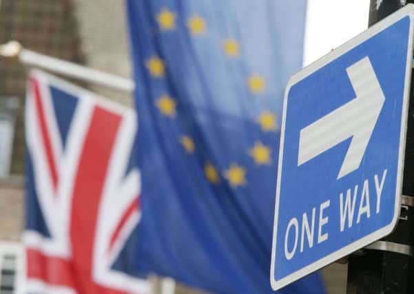 A road traffic sign is in front of the Union Jack and the European Union flag hanging outside Europe House in Smith Square, London. Photo credit: Yui Mok/PA Wire