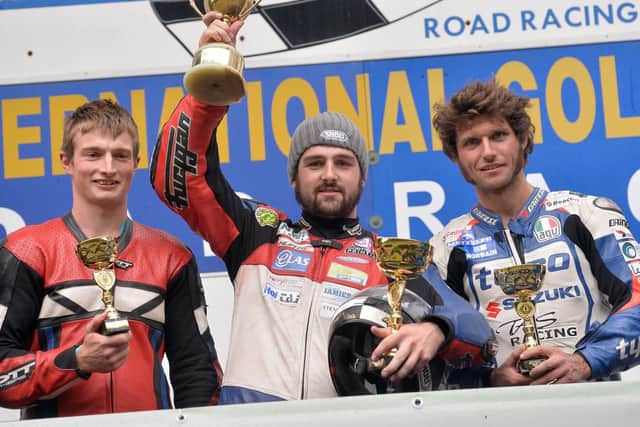 Gold Cup winner Michael Dunlop on the podium with runner-up Guy Martin and James Cowton in 2013.