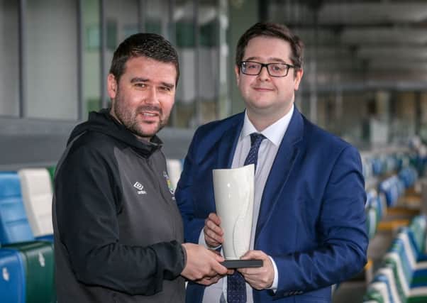 David Healy collects the Belleek trophy from NIFWA Chairman Keith Bailie