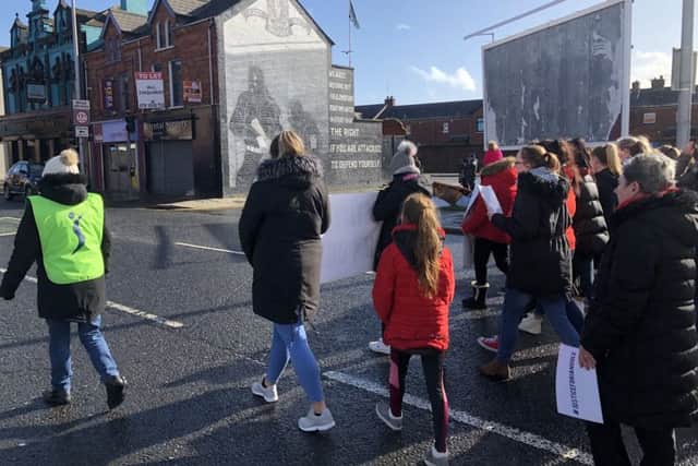 Demonstrators marking Women's Day hold a march in east Belfast against paramilitary intimidation following the murder of Ian Ogle on January 27