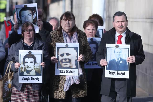 Family members hold images of those who died in disputed circumstance in Ballymurphy in 1971, outside Laganside Courts in Belfast as the inquest into their deaths continues.