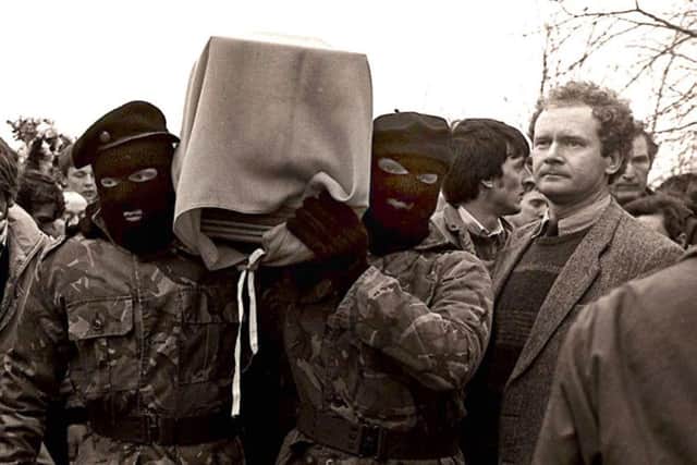 Sinn Fein vice-president Martin McGuinness pictured with masked IRA men at the funeral of Brendan Burns, 1988