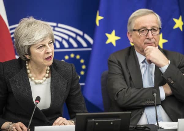 Britain's Prime Minister Theresa May, left, and European Commission President Jean-Claude Juncker attend a media conference at the European Parliament in Strasbourg, eastern France, Monday, March 11, 2019 (AP Photo/Jean-Francois Badias)