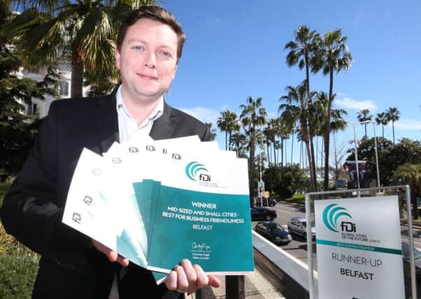 Cllr Dónal Lyons shows off the eight fDi magazine awards won by Belfast during the MIPIM conference in Cannes