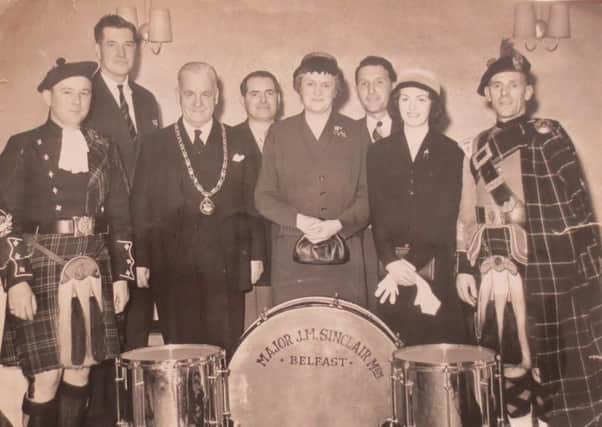 This mid 1950s photograph shows the platform party at the ceremony to amalgamate the Immanuel Old Boys and William Johnston Memorial Pipe Bands to form the Major Sinclair Memorial Pipe Band . 
L to R: PM Leslie McCourt (Immanuel OB), Brum Henderson, JA Faulkner (SPBA President), Bobby Graham, Mrs Maynard Sinclair, Mr and Mrs Herbie Harrison and PM John Finlay (Wm Johnston Memorial).