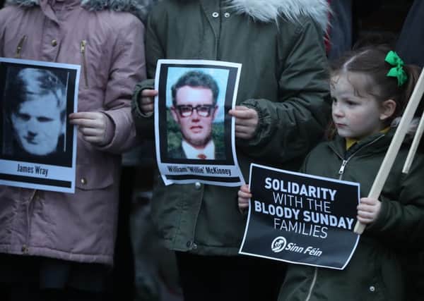Pictures of Bloody Sunday victims James Wray and William McKinney during a vigil in West Belfast last night after the announcement that one former paratrooper is to be charged with murder on Bloody Sunday in Londonderry in 1972.  Photo: Niall Carson/PA Wire