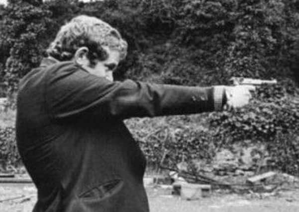 Martin McGuinness in his younger days with a pistol.  The Saville Inquiry found he was probably carrying a Thompson sub machine gun on Bloody Sunday.