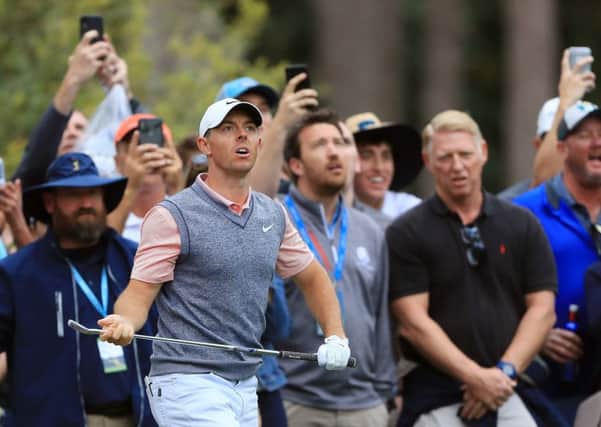 Rory McIlroy of Northern Ireland reacts to his second shot on the tenth hole during the third round of The Players Championship