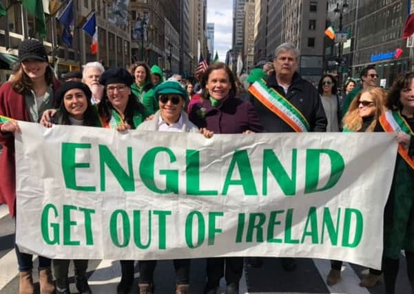 Sinn Fein leader Mary Lou McDonald posted the picture of herself (centre) behind the banner along with Irish republican supporters in the US