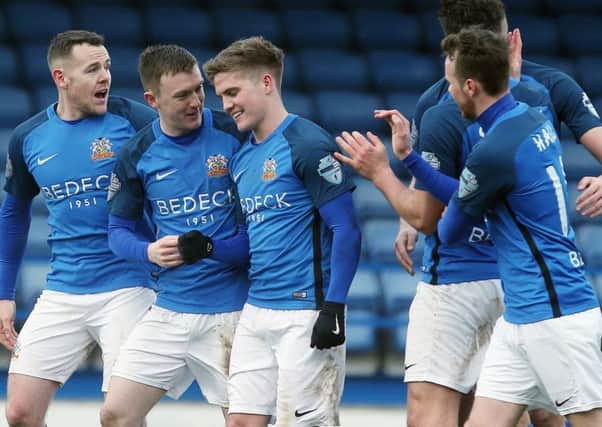 Josh Daniels (centre) and Glenavon team-mates celebrate the game's only goal on Saturday against Dungannon Swifts. Pic by  INPHO.