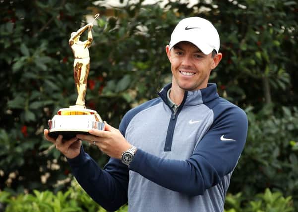 Rory McIlroy of Northern Ireland celebrates with the trophy after winning The PLAYERS Championship on The Stadium Course at TPC Sawgrass
