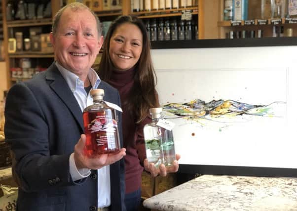 Noel Mills (Mourne Dew Distillery) and Kathryn Callaghan celebrate the launch of the new gin and and artwork at the Poachers Pocket Pantry in County Down, Lisbane.