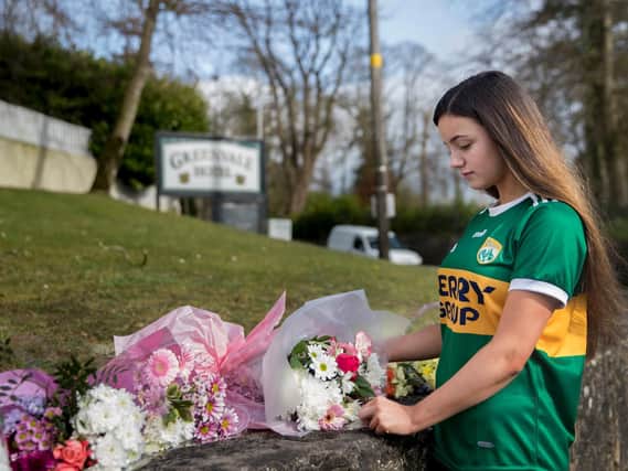 Eboney Johnston, 16, leaving floral tributes at The Greenvale Hotel in Cookstown, Co. Tyrone, in Northern Ireland