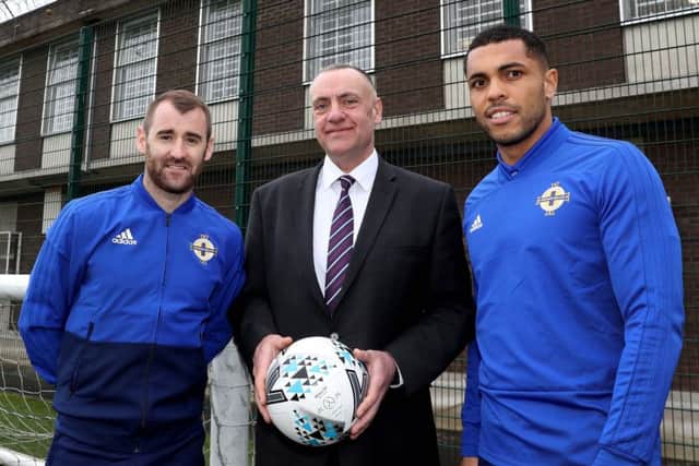 Northern Ireland's Niall McGinn and Josh Magennis with Maghaberry Prison governor David Kennedy during their visit to the 'Stay Onside' programme at HMP Maghaberry