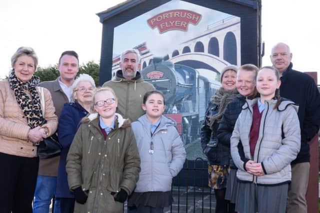 At the unveiling are Hollybank Primary School pupils, Tiarea, Alicia, Faith and Jasmin, with acting principal Lynsey Brett and school governor Vivian Robinson, Mark Cooper from the Monkstown Community Association, artist Dee Craig and John Reid from the Housing Executive
