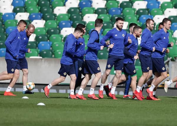 Northern Ireland's Gareth McAuley leads his teammates  during training